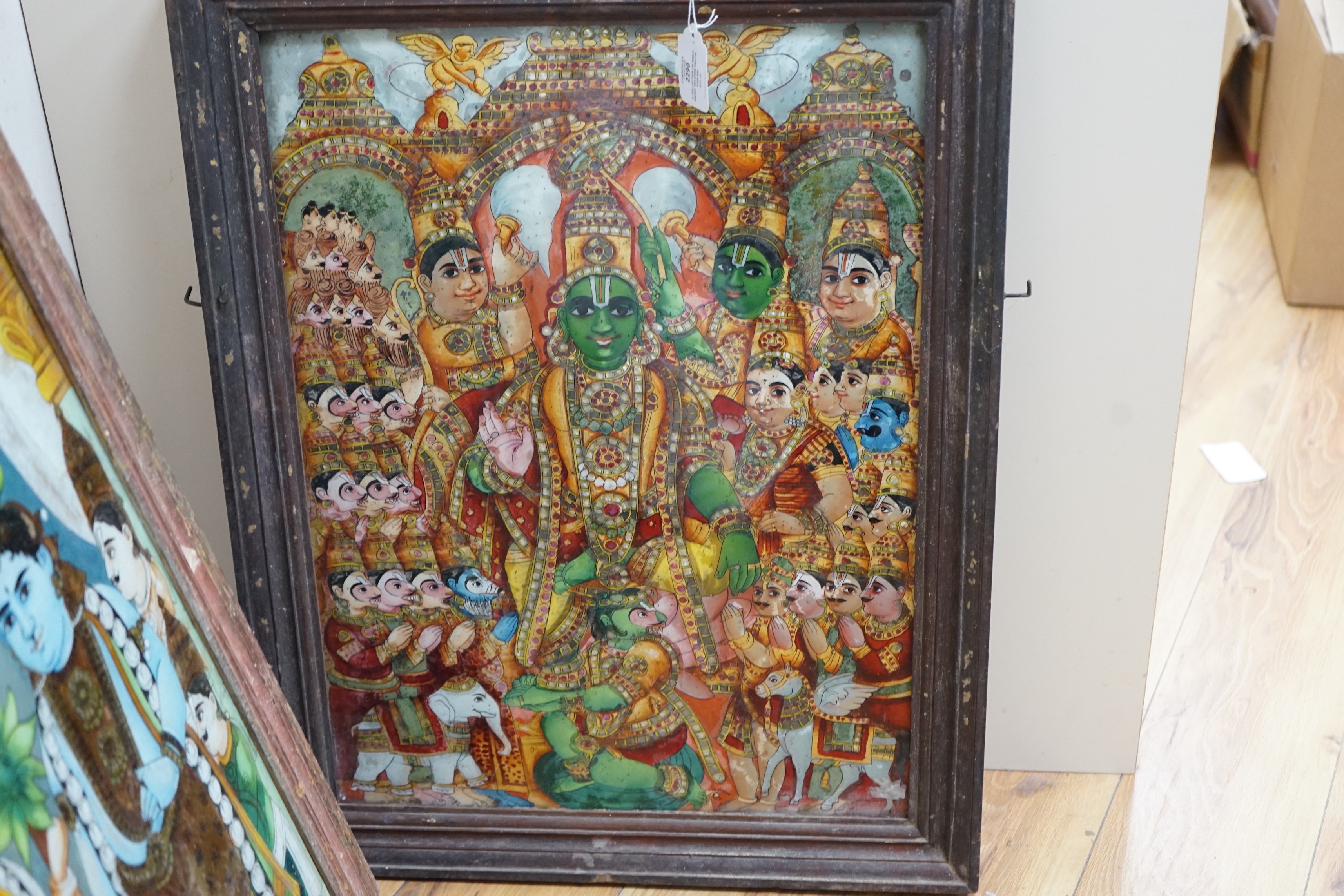 A collection of eight Indian reverse decorated glass pictures, 20th century, largest frame 70cm X 60cm